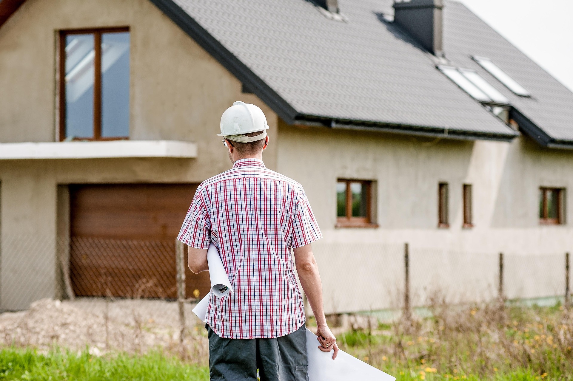 builder planning work outside of house